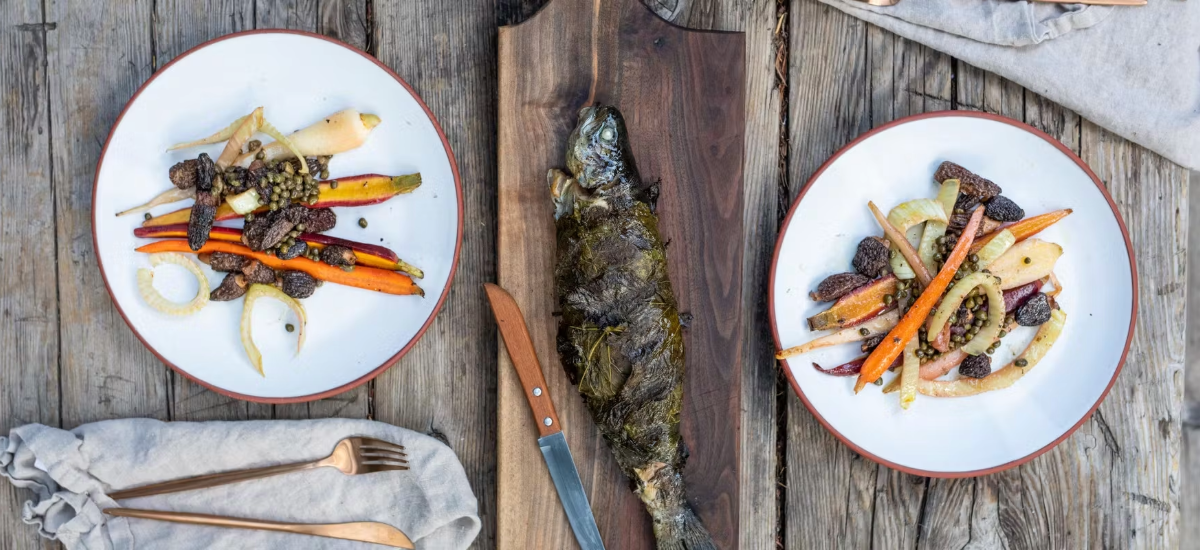 SPIT-ROASTED TROUT IN GRAPE LEAVES WITH MORELS, CARROTS AND FENNEL